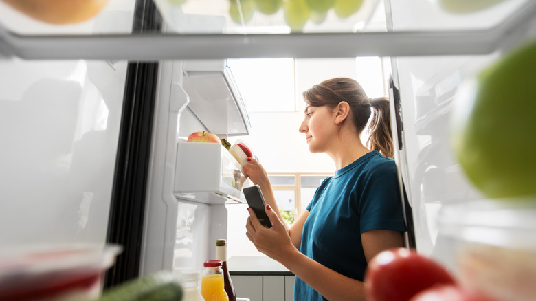 woman checking her fridge