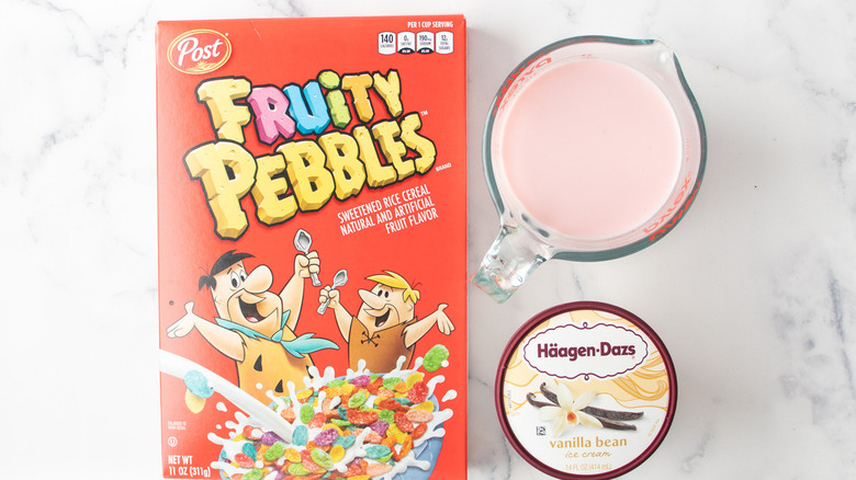 box of Fruity Pebbles cereal with ice cream carton and strawberry milk