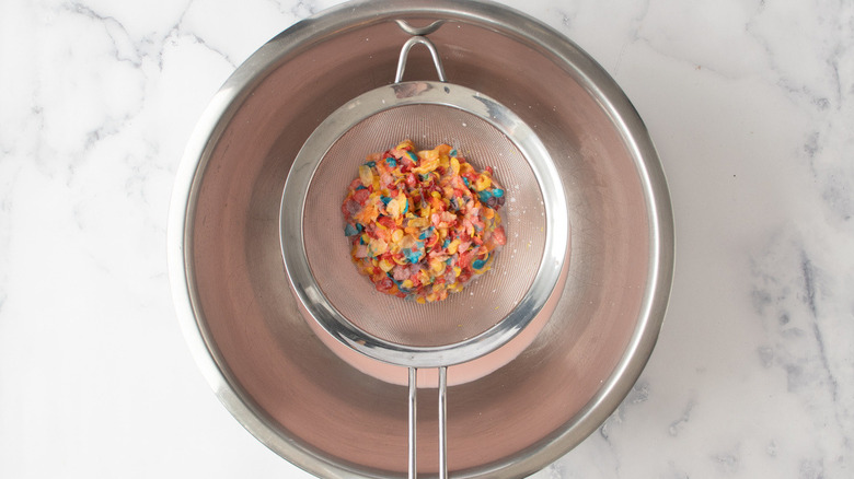 soggy Fruity Pebbles cereal in strainer