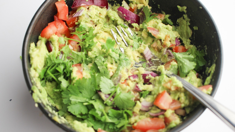 fork mixing ingredients in bowl 