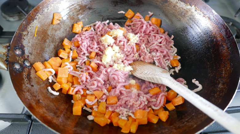 carrots and pork in a wok 