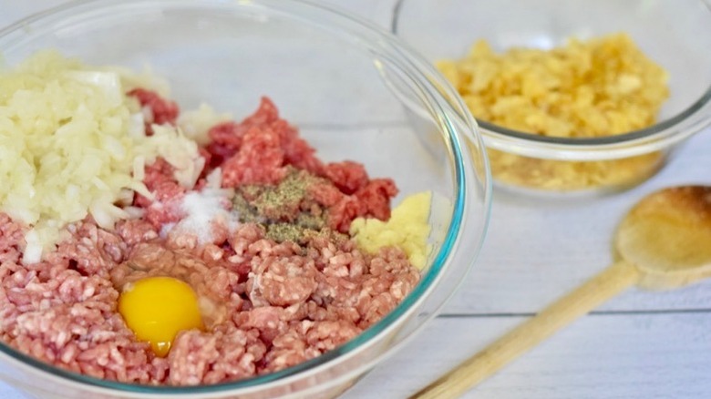raw meat with egg, onion, garlic, salt and pepper