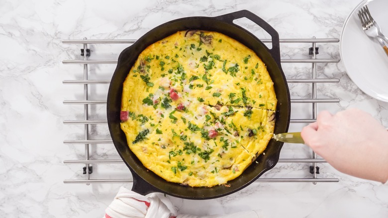 Spinach frittata in a cast iron pan on a countertop