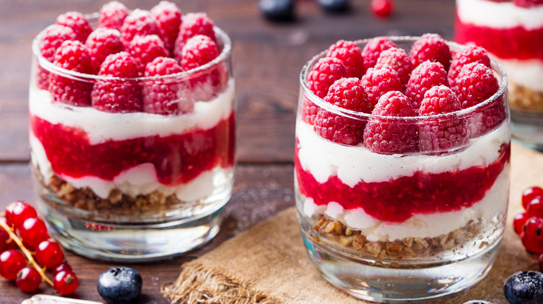 Raspberry, cream, and biscuit trifle in glass cups