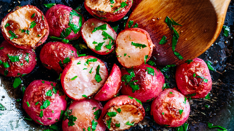 Fried radishes and wooden spoon