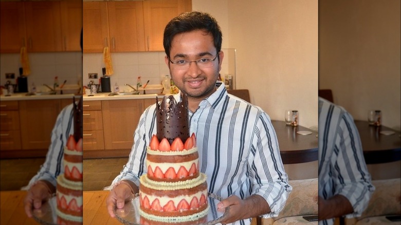 Rahul Mandal holds towering cake