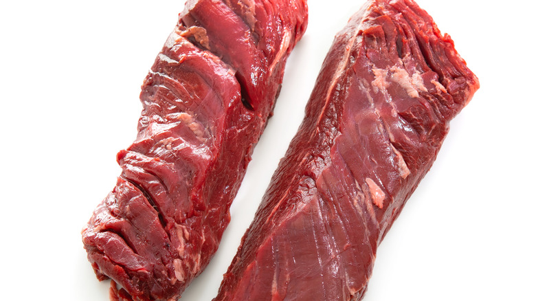 Raw hanger steaks on white background