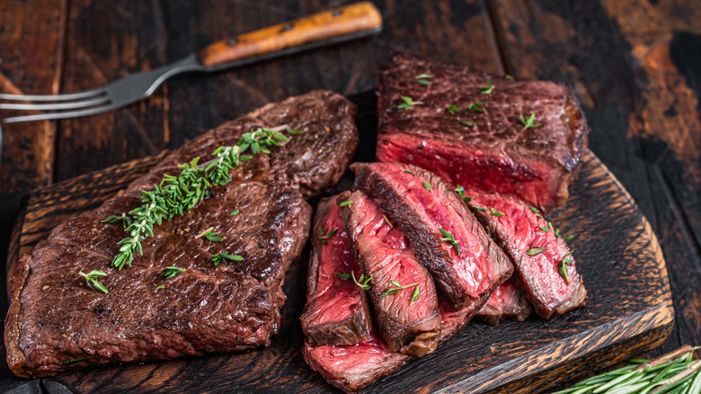 Cooked skirt steak on wooden board