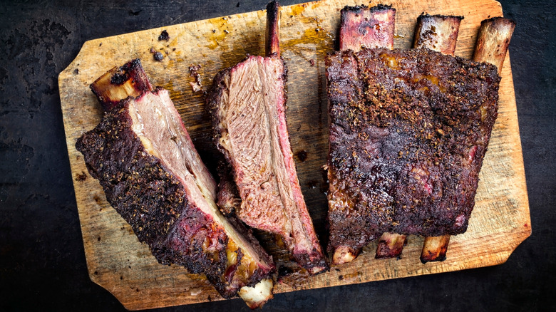 Five beef ribs on cutting board