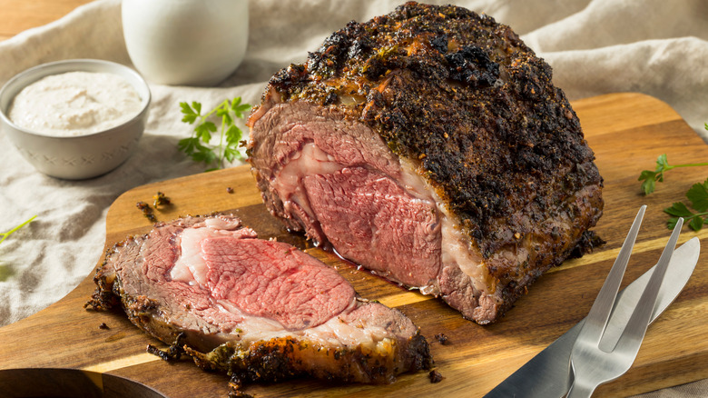 smoked prime rib carved on cutting board