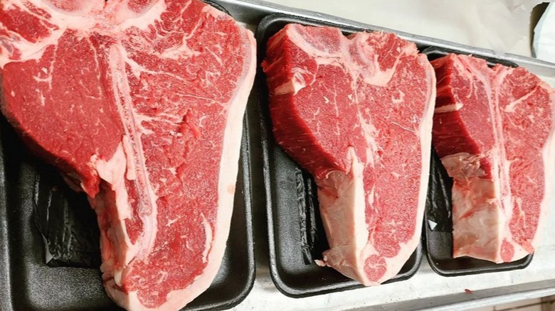 Short loin T-bone steaks on black trays
