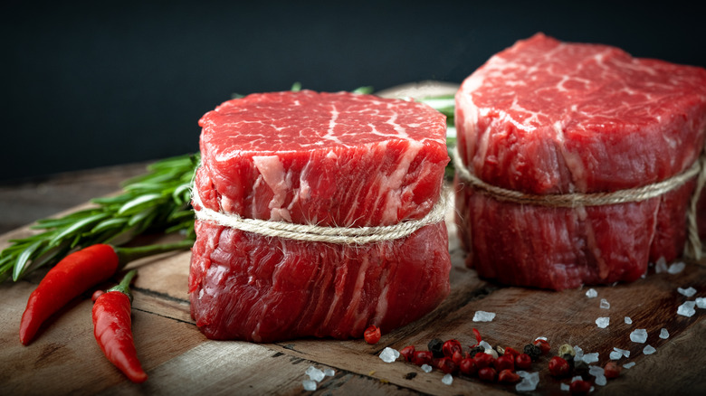 Raw filet mignon on cutting board