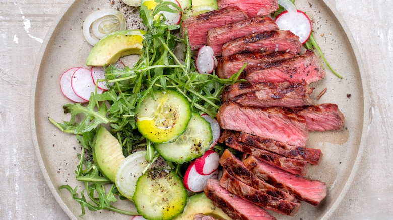 sliced skirt steak and salad