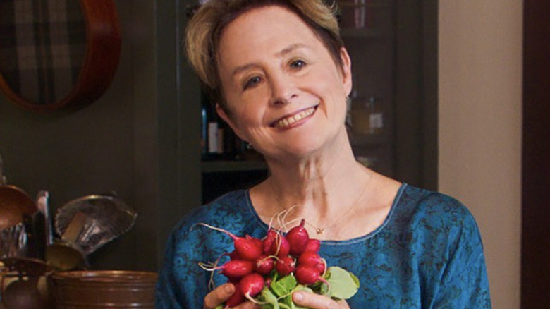 Alice Waters posing with radishes