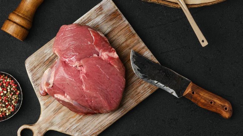 Raw petite sirloin with knife