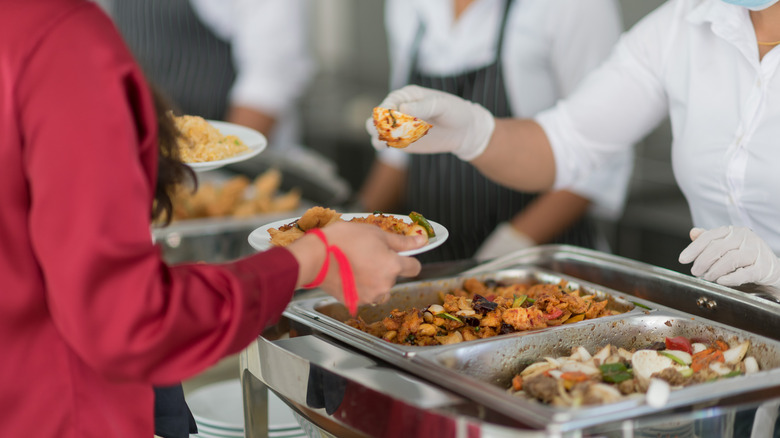 Woman getting food from buffet