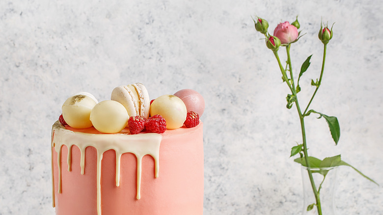 Pink cake topped with raspberries 