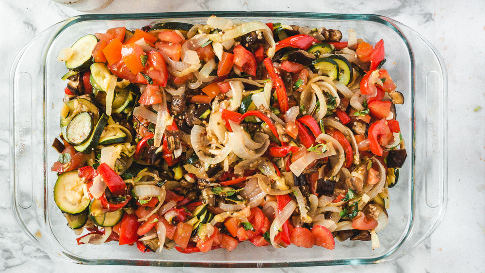 half-baked vegetables in baking dish for late summer ratatouille