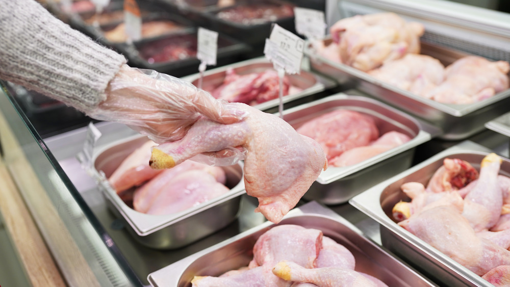 Women shopping for chicken at store