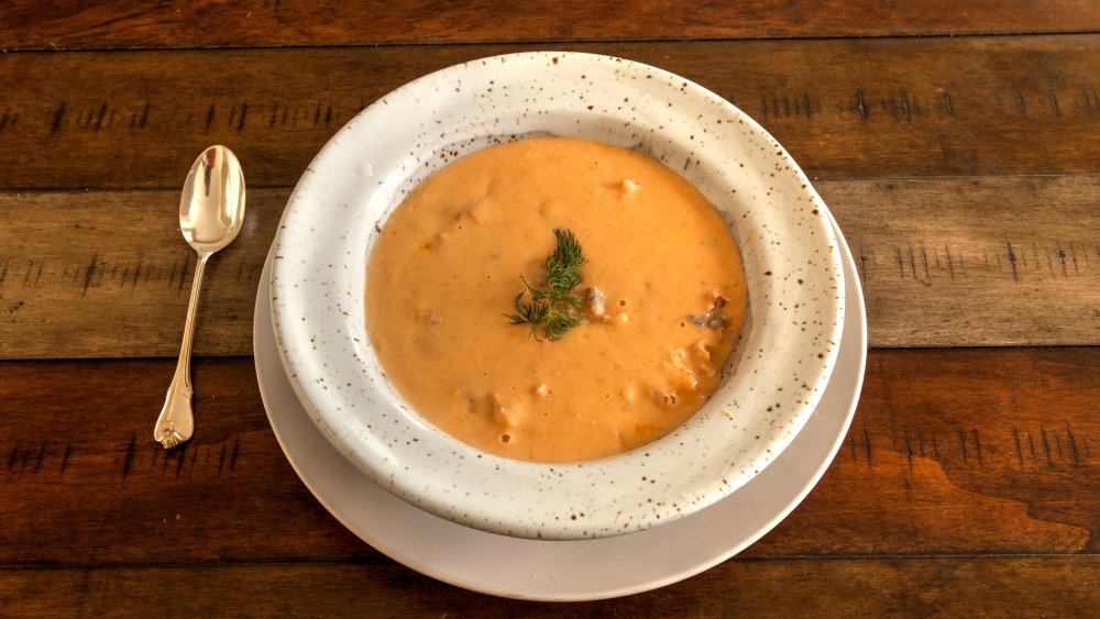 A bowl of lobster bisque garnished with dill