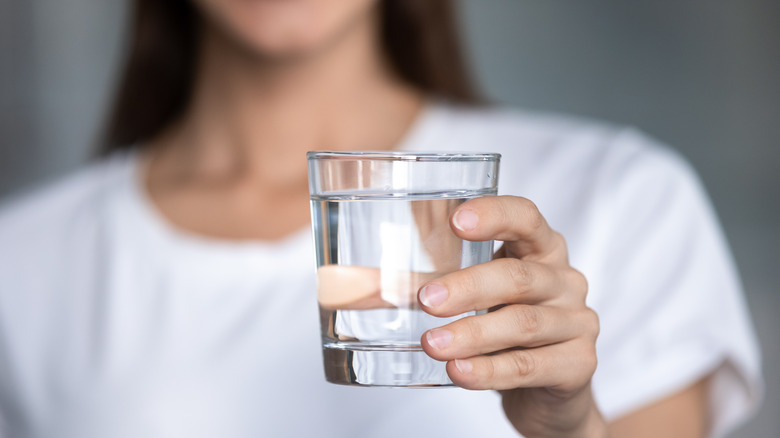 Woman holding a glass of water 