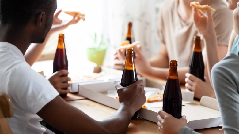 friends eating pizza and drinking beer