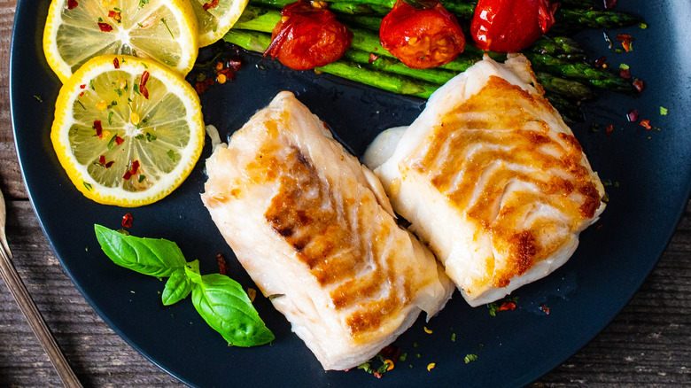 Fried cod on a black plate