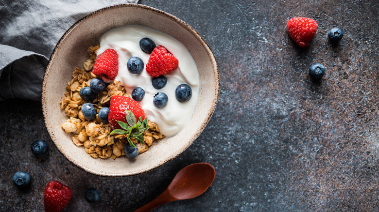 bowl of cereal with yogurt blueberries strawberries