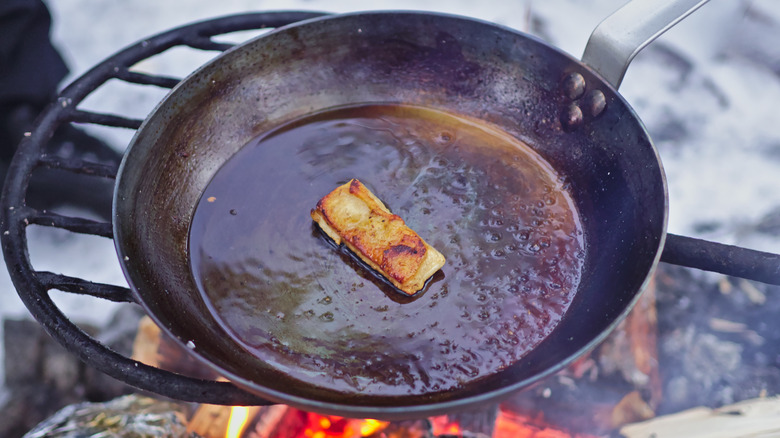 Cooking in a carbon steel pan on open fire