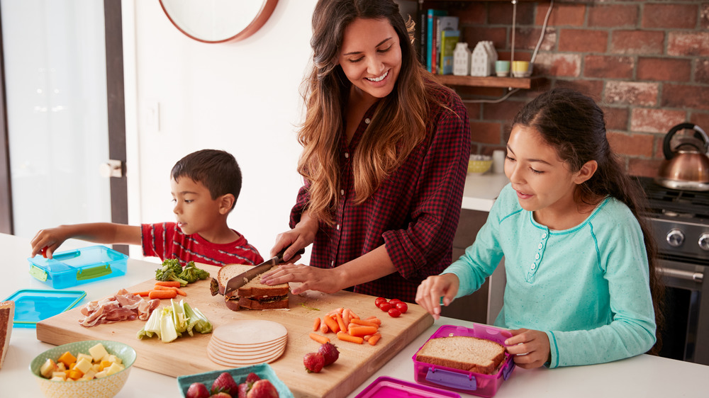 family kids making school lunches