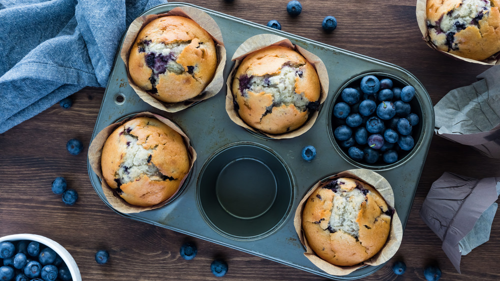 Blueberry muffins in a muffin tin. Baked goods concept.