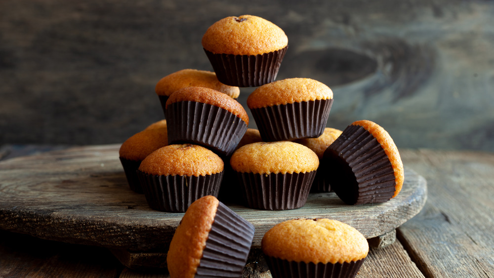 Pile of muffins on a wooden board