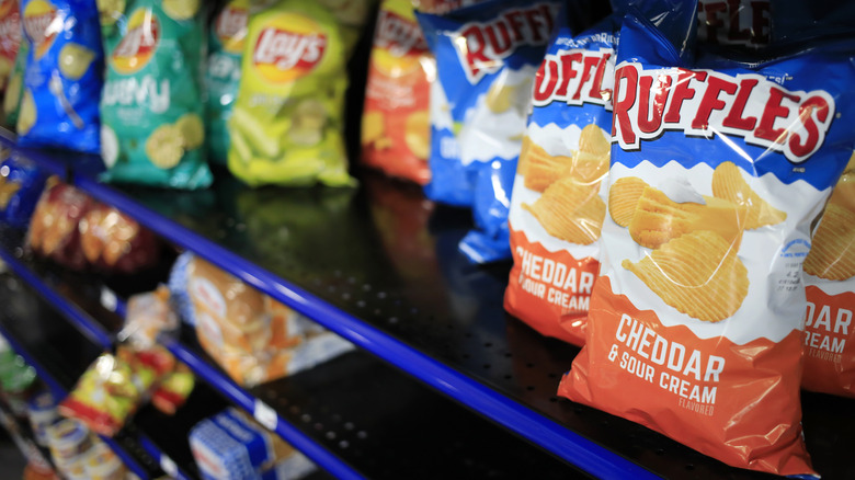 A shelf with Ruffle chips 