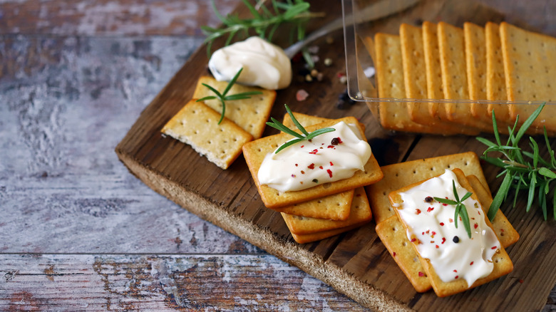 Wooden tray of crackers with cheese