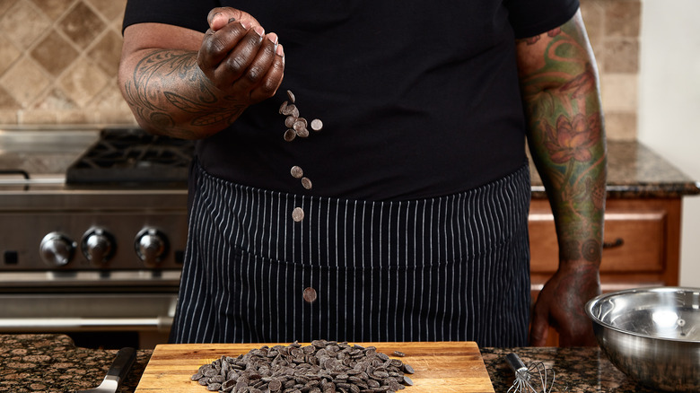 Phillip Ashley Rix dropping chocolate onto cutting board