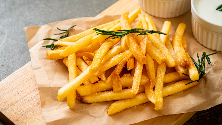 French fries on a wooden board