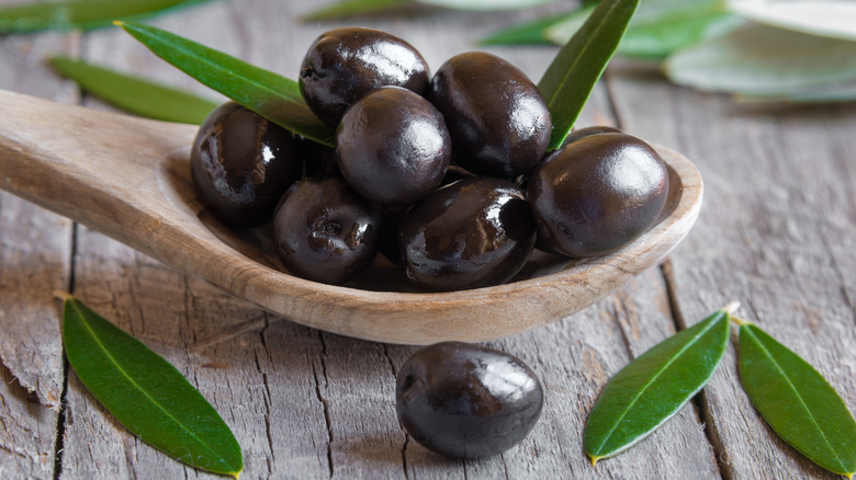 Black olives on a spoon