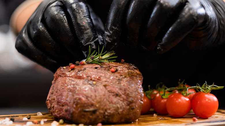 chef preparing steak steakhouse