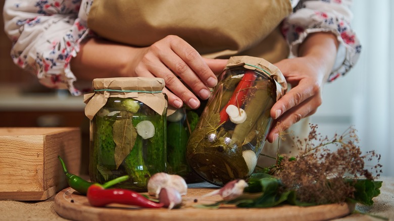 woman canning pickles at home