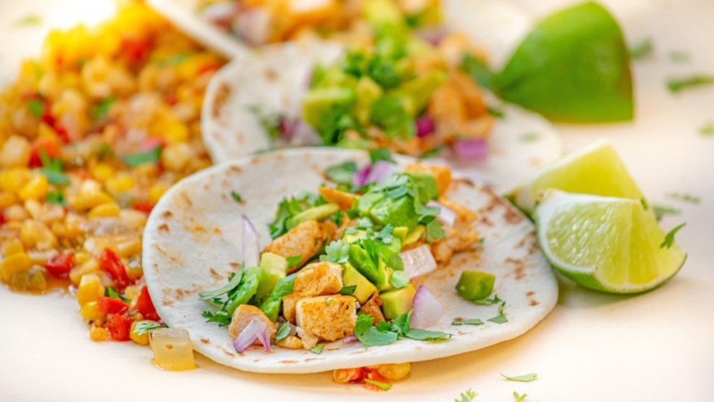 Tacos resting on a bed of vegetables