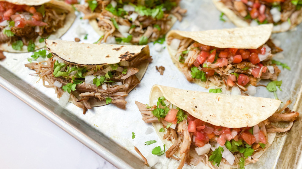 Shredded meat tacos on a pan
