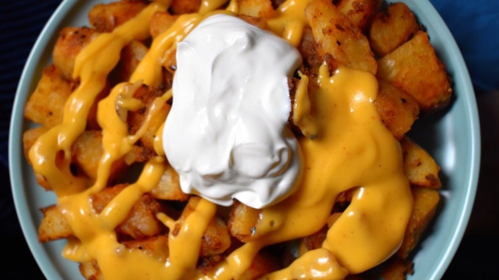 Potatoes covered in cheese and sour cream