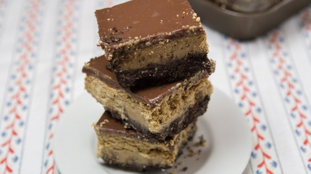 stack of peanut butter ganache bars on a plate