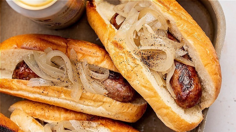 bratwurst in buns with onions