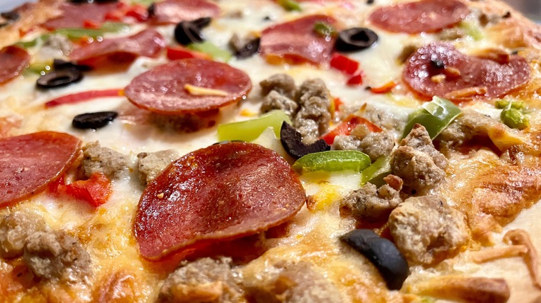 A close-up shot of the toppings on a Tombstone supreme pizza