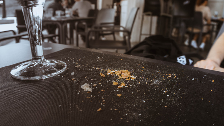 Dining table covered with crumbs