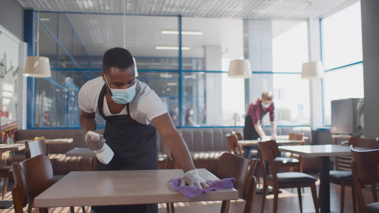 restaurant staff cleaning tables