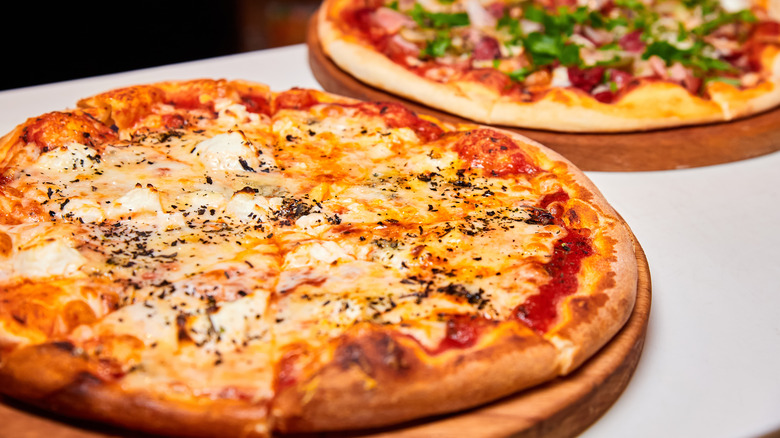 fresh pizza pies on display 