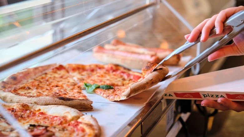 serving from pizza display case