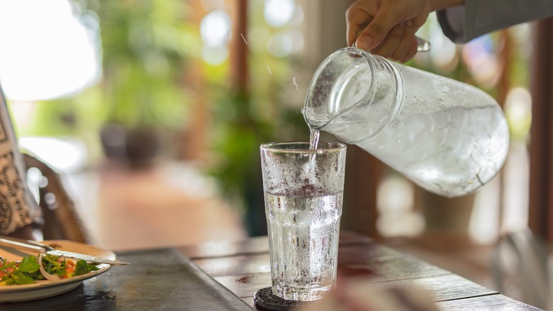 Iced water being poured into a glass